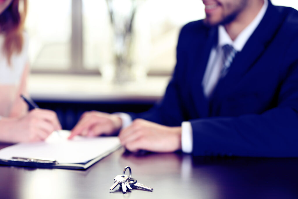 Signing of contract and keys on table, close-up